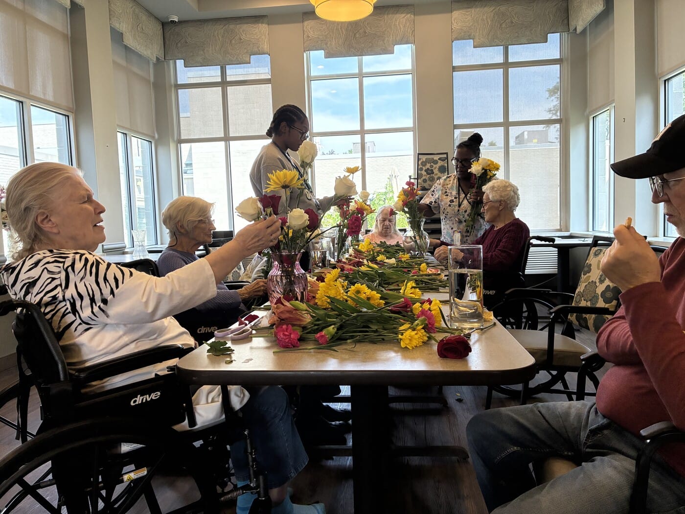 Residents arranging flowers with the staff