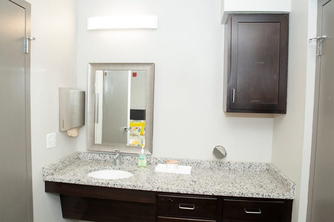 Resident rooms include a large vanity with storage.