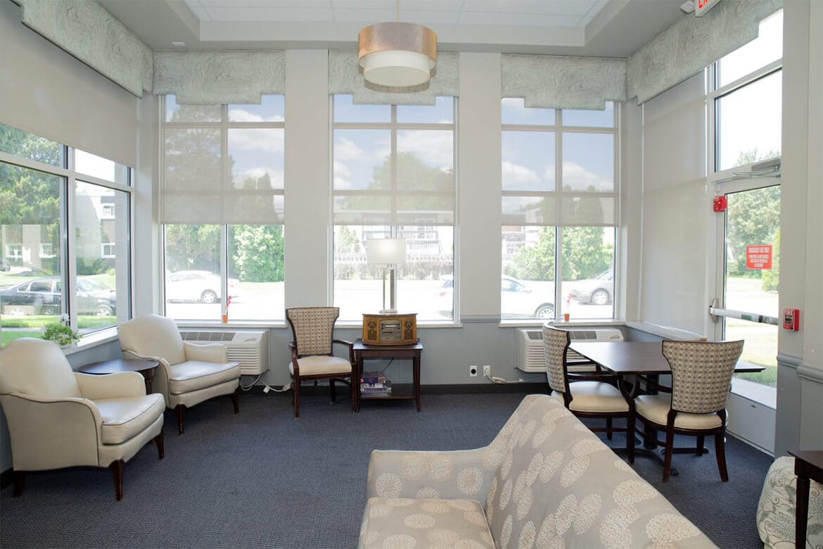 Large windows in this living room look out on our neighborhood setting.